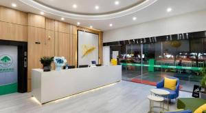 a lobby with a reception desk and chairs in a building at GreenTree Inn Express Fujian Ningde Ningchuan Road Qinghua Building in Ningde
