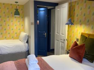 a room with two beds and a blue door at Dream Stays Bath - Kingsmead Street in Bath