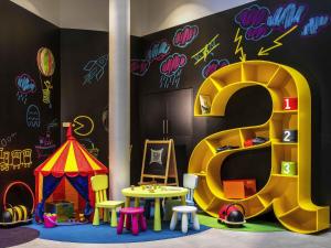 a play room with a play tent and a play table at Ibis Styles Budapest Center in Budapest