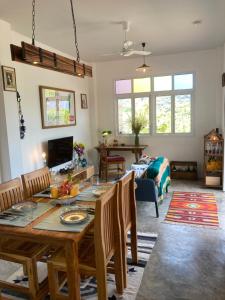 Ko Bu BuにあるBoho-Luxe Pool Villa with Simply Amazing Viewsの木製のテーブルと椅子のあるリビングルーム