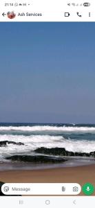 a screenshot of the ocean with a picture of the beach at Wave Watcher in Amanzimtoti