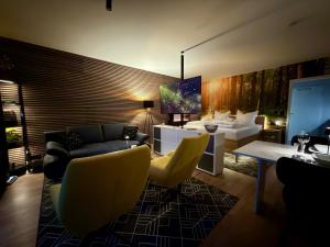 a living room with a couch and a table and chairs at Apartment Pistenzauber in Winterberg