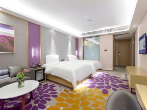 a bedroom with a large bed and a living room at Lavande Hotel Huizhou Shiwan in Shiwan +192 photos