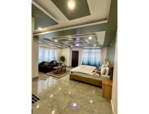 a bedroom with a bed and a living room at Ana SonamTsomu, Tawang in Tawang