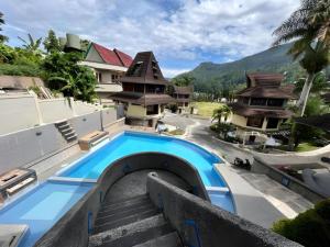 a resort with a swimming pool and some buildings at Sapadia Hotel Parapat in Parapat