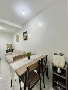 a living room with a table and a couch at 2BR Family Condo for 6pax near IT Park Budget Stay at Urban Deca Homes Banilad by Gerra unit Nathan in Mandaue City