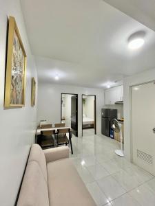 a living room with a couch and a table at 2BR Family Condo for 6pax near IT Park Budget Stay at Urban Deca Homes Banilad by Gerra unit Nathan in Mandaue City