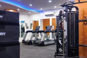 a gym with rows of tread machines in a room at Kandi Heaven in White Tower in Angeles