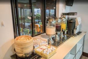 a kitchen counter with aasteryasteryasteryasteryasteryasteryasteryasteryasteryasteryastery at Ximen Relite Hotel in Taipei