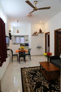 a living room with a couch and a table at Go COOL-IN in Yercaud