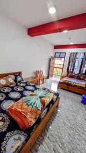 a bedroom with a bed and a couch in a room at Vista Valley View homestay in Dirang Dzong