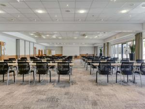 a large room with tables and chairs in it at Novotel Köln City in Cologne