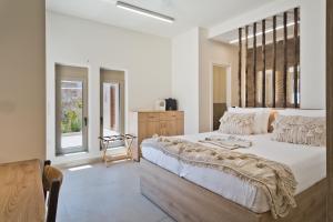 a bedroom with a large bed and a window at C'est La Vie Beach Villa 1 Ammopi Karpathos in Amoopi +134 photos