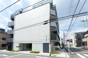 a white building with a sign on the side of it at -シーフォルム京急蒲田-Entire Unit in Tokyo