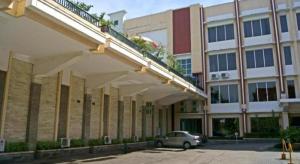 a car parked in a parking lot in front of a building at Karlita Hotel Tegal in Tegal