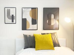 a bedroom with four pictures on the wall above a bed at -シーフォルム京急蒲田-Entire Unit in Tokyo