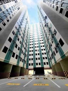 a large tall building with a lot of windows at 2BR Family Condo for 6pax near IT Park Budget Stay at Urban Deca Homes Banilad by Gerra unit Nathan in Mandaue City