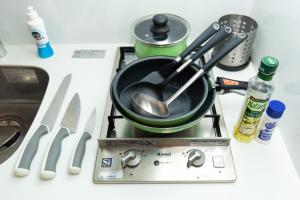 a pot on top of a stove with utensils at -シーフォルム京急蒲田-Entire Unit in Tokyo