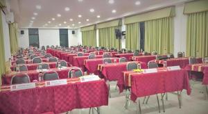 a room full of tables and chairs with pink table cloths at Breeze Hill Resort in Campson +155 photos