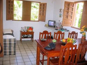 a kitchen with a table and chairs and a dining room at Privê Village Maragogi in Maragogi