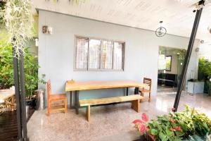 une salle à manger avec une table et des chaises en bois dans l'établissement OYO 732 Juthamas Hotel, à Ban Nai
