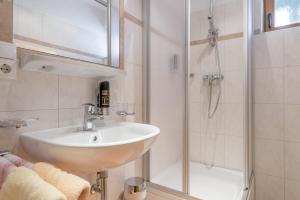 a bathroom with a sink and a shower at Ferienwohnungen Haus Daheim in Längenfeld