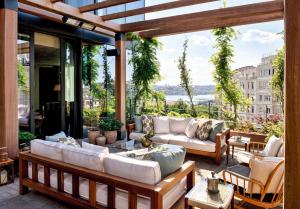a patio with couches and a view of the city at Soho House Istanbul in Istanbul