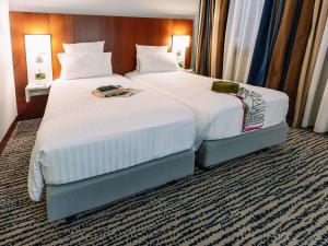 Ένα ή περισσότερα κρεβάτια σε δωμάτιο στο Mercure Roma Piazza Bologna