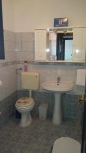 a bathroom with a toilet and a sink at Apartment Melina in Omišalj +24 photos