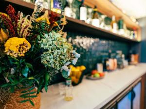 a bouquet of flowers on a counter in a bar at Ibis Styles Madrid Centro Maravillas in Madrid +104 photos
