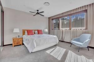 a bedroom with a bed and a chair and a window at The Haven Montville in Montville