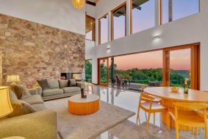 a living room with a table and a stone wall at The Haven Montville in Montville