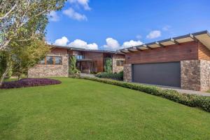 a house with a garage in front of a yard at The Haven Montville in Montville