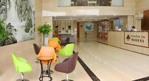 a lobby with chairs and tables in a building at GreenTree Inn Fuzhou Eastern Capital Express Hotel in Shiliting