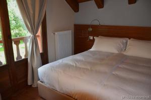 מיטה או מיטות בחדר ב-Residence Orma