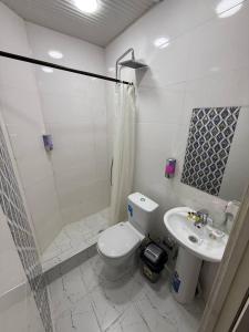 a bathroom with a shower and a toilet and a sink at Minor Hotel in Toshkent-Passajir Bekati +20 photos