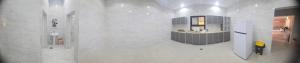 a white bathroom with a sink and a counter at منتجع حبايبي in Al Mubarraz
