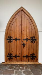 a large wooden door with an ornate gate at Luxury Mansion 7bdrm 6bth pool pizza ovn 25mns CBD in Silverdale