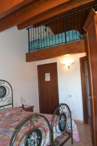 a bedroom with a bed with a wrought iron bed frame at Agriturismo Montorso in Monte Rinaldo +49 photos