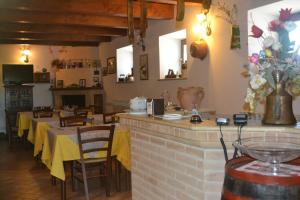 a restaurant with tables and chairs in a room at Agriturismo Montorso in Monte Rinaldo