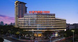 a large building with red words on top of it at Leisure Hotel in Dongguan