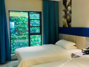 a bedroom with a bed and a large window at 7 Days Premium Suzhou Mudu Ancient Town in Suzhou