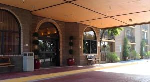 a building with arches and a bench in front of it at Alhambra Hotel in Alhambra