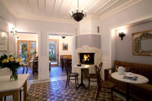 a living room with a fireplace and a table and chairs at Hotel Empress Zoe in Istanbul