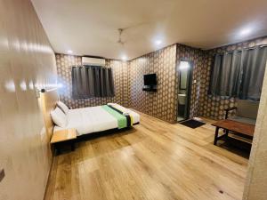 a bedroom with a bed and a couch in a room at SwagStay Hotel OwnHouse 181 Nagpur in Nagpur +17 photos