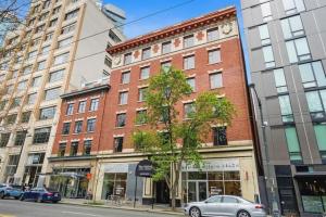 a building on a city street with cars parked in front at The Oxford Seattle-Downtown in Seattle