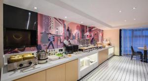 a restaurant kitchen with a counter with food at City Comfort Inn Nanning Normal University Mingxiu Metro Station in Nanning