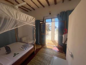 Postel nebo postele na pokoji v ubytování Zanzibar beach escape 1&2