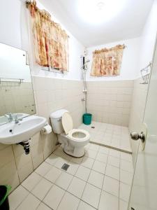 a bathroom with a toilet and a sink at Panglao Ramyer Villa 1 in Sampong