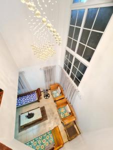 an attic room with a chandelier and a table at Panglao Ramyer Villa 1 in Sampong